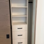 Arctic reach-in closet with flat drawer fronts and black hardware. Snowmass Village, CO