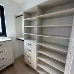 Arctic walk-in closet with modern drawer fronts and black hardware. Carbondale, CO