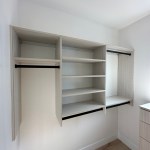 Arctic walk-in closet with modern drawer fronts and black hardware. Carbondale, CO